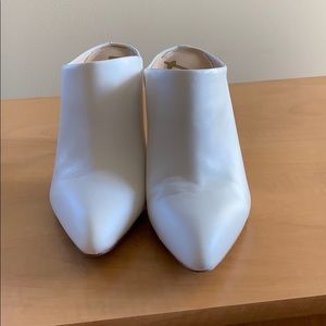 White high-heeled mules